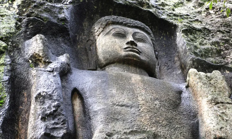 Majestic rock-cut Buddha statue inside the historic Dova Cave Temple in Sri Lanka.