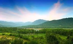 A scenic view of lush green forests and rolling hills of the Ravana Goda in Kotmale valley, Sri Lanka. The image highlights the picturesque landscape of the area, surrounded by natural beauty.